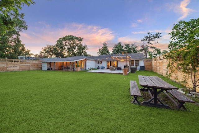 4509 Randwick Dr, Houston, TX 77092 - back of house at dusk with a patio and outdoor dining space