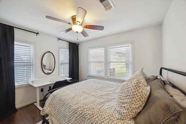 4509 Randwick Dr, Houston, TX 77092 - bedroom featuring dark wood-style flooring, multiple windows, ceiling fan, and baseboards