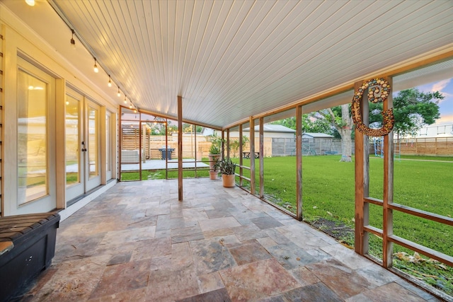 4509 Randwick Dr, Houston, TX 77092 - unfurnished sunroom featuring rail lighting, stone tile flooring, french doors, vaulted ceiling, and wood ceiling