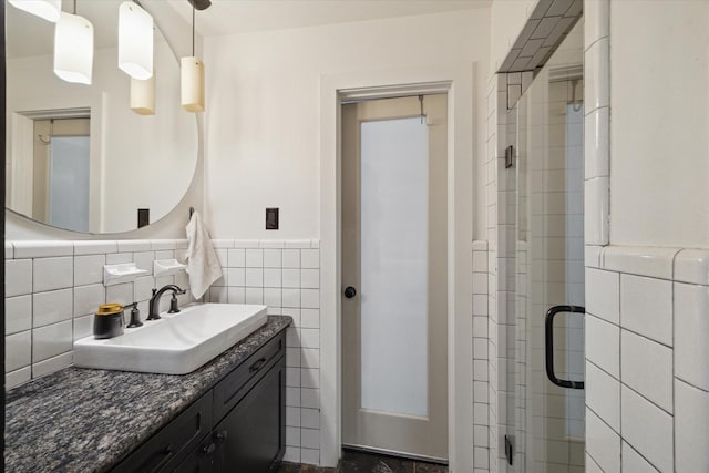 4509 Randwick Dr, Houston, TX 77092 - bathroom featuring a shower stall, vanity, tile walls, and wainscoting