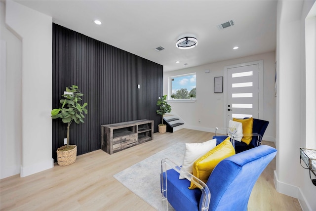 2114 Des Chaumes St, Houston, TX 77026 - living room with wood finished floors, baseboards, recessed lighting, and an accent wall