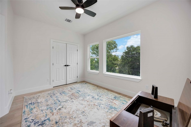 2114 Des Chaumes St, Houston, TX 77026 - bedroom with baseboards, an office area, light wood finished floors, and a closet