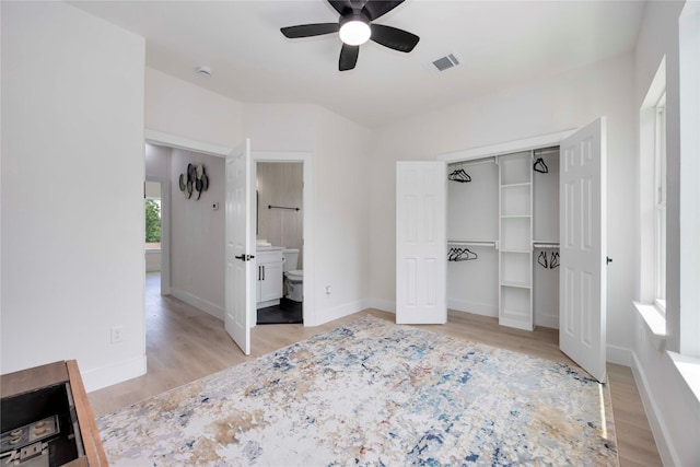 2114 Des Chaumes St, Houston, TX 77026 - unfurnished bedroom featuring light wood-style floors, a closet, baseboards, and connected bathroom