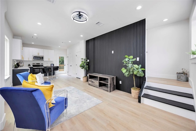 2114 Des Chaumes St, Houston, TX 77026 - living area with light wood-style floors, recessed lighting, and baseboards