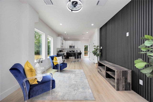 2114 Des Chaumes St, Houston, TX 77026 - living room featuring light wood finished floors, plenty of natural light, recessed lighting, and baseboards