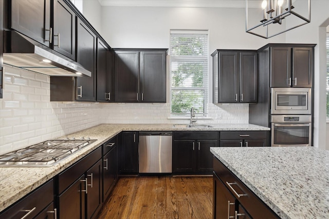 5644 Larkin St, Houston, TX 77007 - kitchen featuring stainless steel appliances, a sink, dark wood finished floors, light stone countertops, and tasteful backsplash