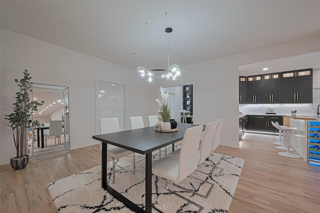 4434 Sarong Dr, Houston, TX 77096 - dining area with light wood-type flooring, a chandelier, and baseboards