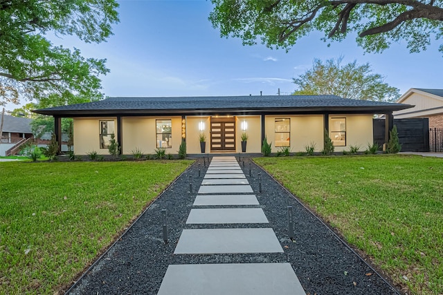 4434 Sarong Dr, Houston, TX 77096 - view of front of house with stucco siding, a front lawn, french doors, and roof with shingles