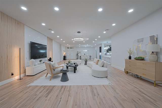 4434 Sarong Dr, Houston, TX 77096 - living room featuring light wood finished floors, baseboards, recessed lighting, and a chandelier