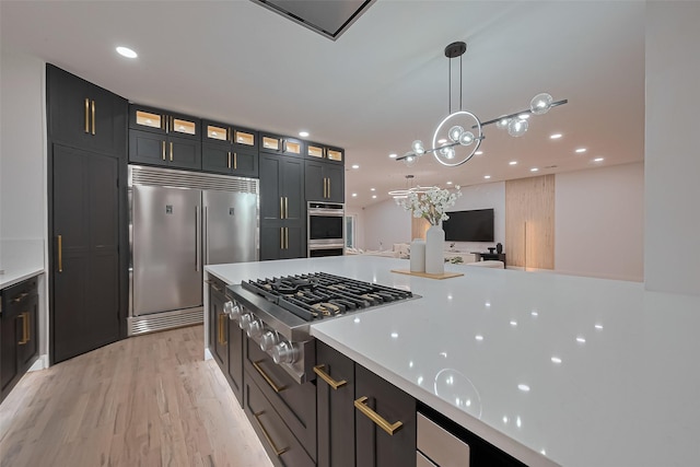 4434 Sarong Dr, Houston, TX 77096 - kitchen with appliances with stainless steel finishes, glass insert cabinets, light wood-style floors, light countertops, and hanging light fixtures