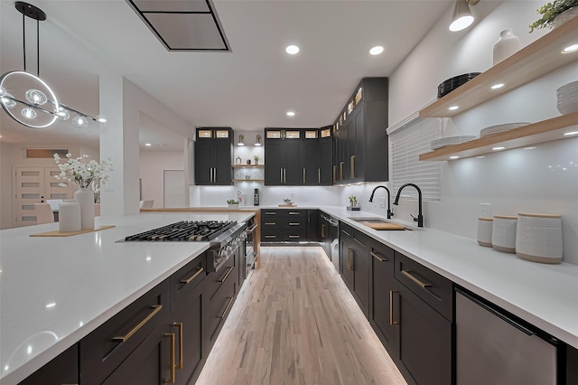 4434 Sarong Dr, Houston, TX 77096 - kitchen featuring open shelves, a sink, light wood-type flooring, pendant lighting, and light countertops