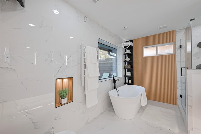 4434 Sarong Dr, Houston, TX 77096 - full bathroom with a marble finish shower, a soaking tub, a towel warming rack, and marble tiled flooring