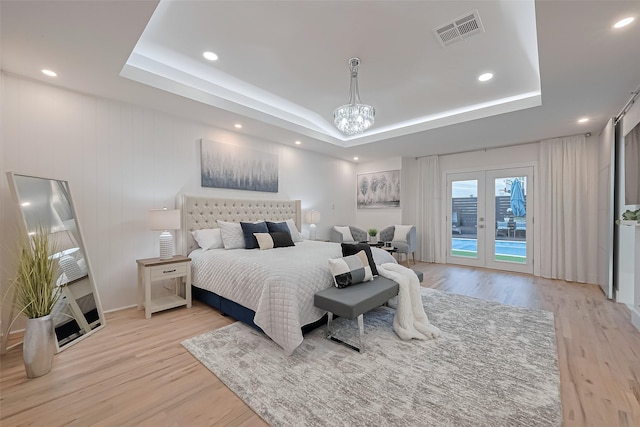4434 Sarong Dr, Houston, TX 77096 - bedroom with a raised ceiling, access to outside, light wood-style floors, french doors, and recessed lighting