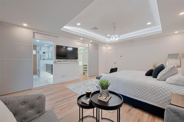 4434 Sarong Dr, Houston, TX 77096 - bedroom featuring a tray ceiling, light wood-type flooring, recessed lighting, connected bathroom, and baseboards