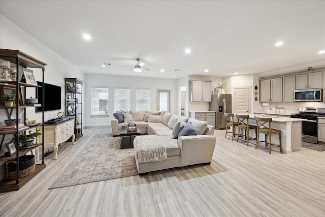 3710 Birtley Bend Way, Fulshear, TX 77441 - living area featuring light wood finished floors, a ceiling fan, recessed lighting, and baseboards