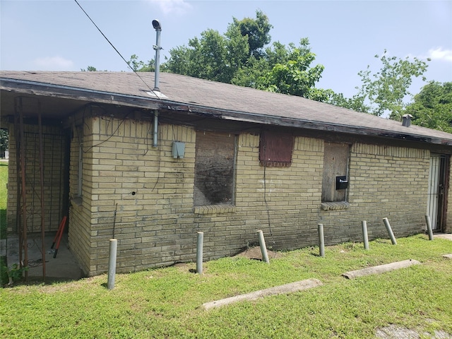 3923 Aledo St, Houston, TX 77051 - view of home's exterior featuring a shingled roof, brick siding, and a yard
