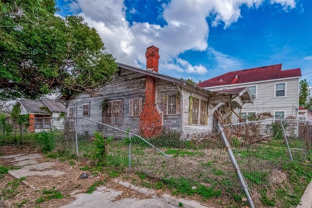 3301 Holman St, Houston, TX 77004 - view of property exterior with a chimney