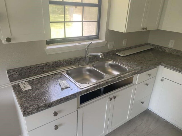 167 County Road 3665 W, Splendora, TX 77372 - kitchen featuring a sink, white cabinets, dark countertops, and light marble finish floors
