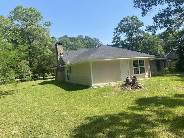 167 County Road 3665 W, Splendora, TX 77372 - rear view of house with a yard and a chimney