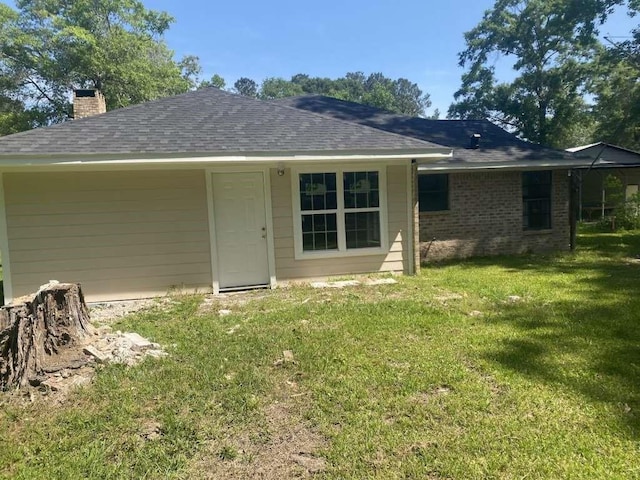 167 County Road 3665 W, Splendora, TX 77372 - back of house featuring a chimney, a lawn, and roof with shingles