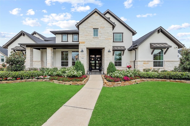 7851 Longhorn Trl, Fulshear, TX 77406 - view of front facade featuring stone siding, stucco siding, a front lawn, and french doors