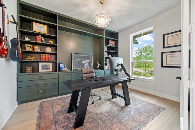 7851 Longhorn Trl, Fulshear, TX 77406 - office area with light wood-style floors, a chandelier, and baseboards