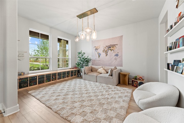 7851 Longhorn Trl, Fulshear, TX 77406 - sitting room with wood finished floors, a chandelier, and built in shelves