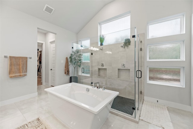 7851 Longhorn Trl, Fulshear, TX 77406 - bathroom with a freestanding tub, a stall shower, a walk in closet, vaulted ceiling, and tile patterned flooring