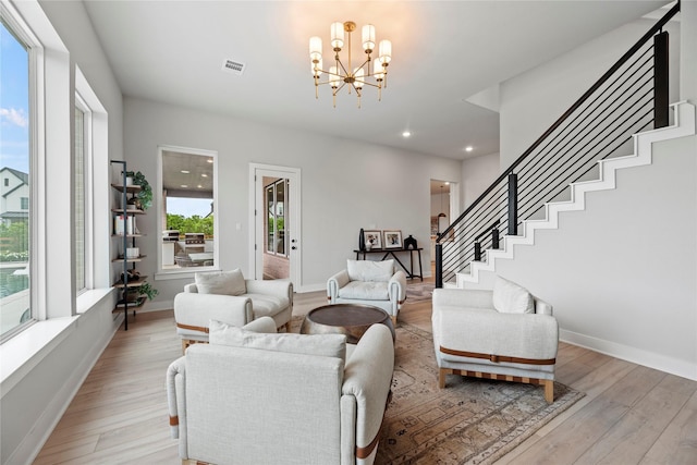 7851 Longhorn Trl, Fulshear, TX 77406 - living room featuring stairs, light wood-style floors, a chandelier, baseboards, and recessed lighting