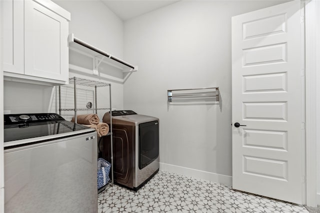 7851 Longhorn Trl, Fulshear, TX 77406 - laundry room featuring separate washer and dryer, cabinet space, light floors, and baseboards