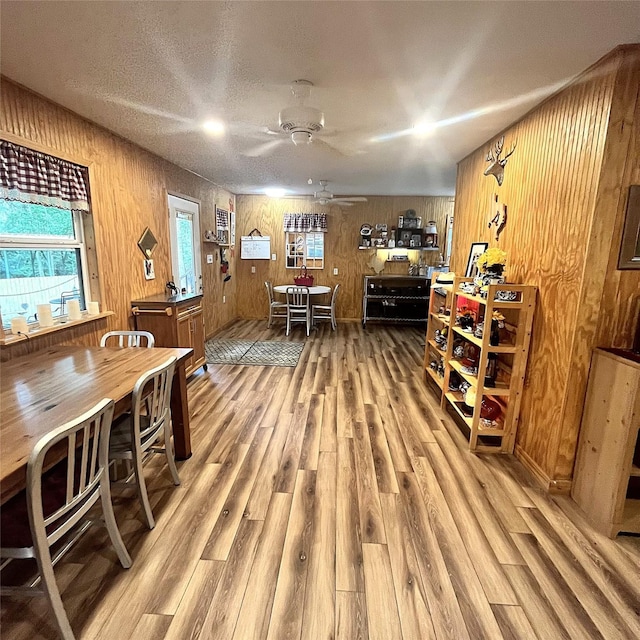 5002 Fm 811, Centerville, TX 75833 - dining room featuring a ceiling fan, wood finished floors, and wood walls