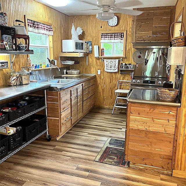 5002 Fm 811, Centerville, TX 75833 - kitchen with stainless steel counters, white microwave, a ceiling fan, light wood-style flooring, and a sink