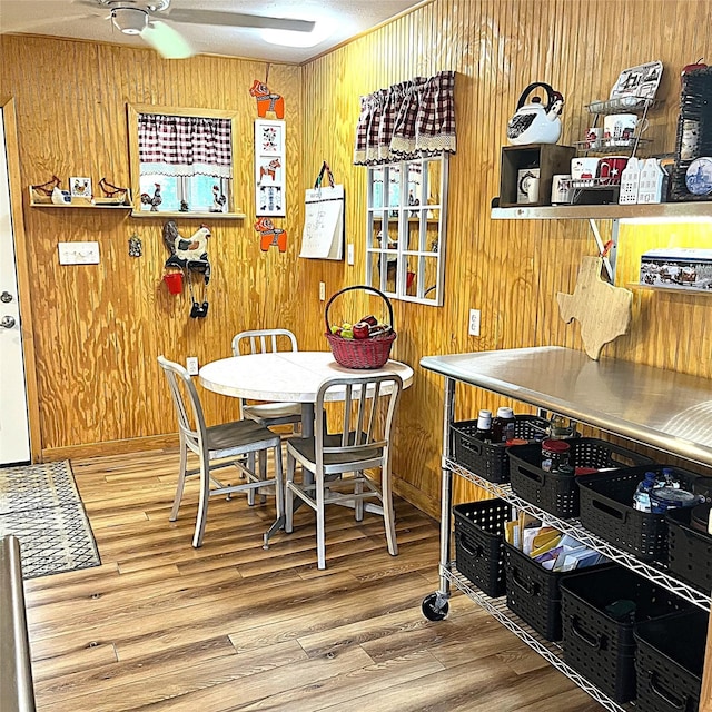 5002 Fm 811, Centerville, TX 75833 - dining room featuring wood finished floors, wooden walls, and ceiling fan