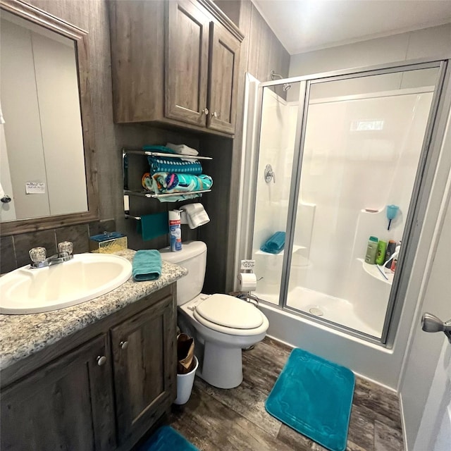 5002 Fm 811, Centerville, TX 75833 - bathroom featuring wood finished floors, a stall shower, vanity, and toilet
