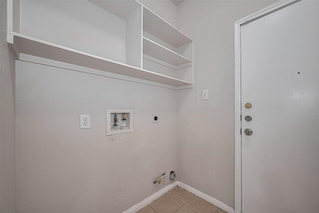 7407 Breda Dr, Baytown, TX 77521 - laundry room featuring hookup for a gas dryer, hookup for an electric dryer, light tile patterned floors, washer hookup, and baseboards
