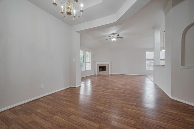 7407 Breda Dr, Baytown, TX 77521 - unfurnished living room with lofted ceiling, a ceiling fan, dark wood-style floors, a chandelier, and baseboards