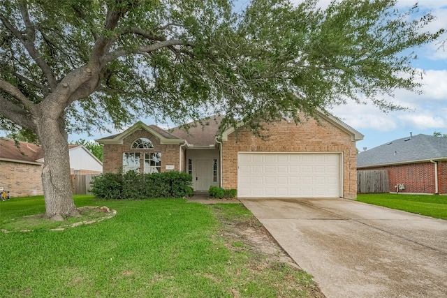 7407 Breda Dr, Baytown, TX 77521 - view of front of home with brick siding, a garage, and driveway