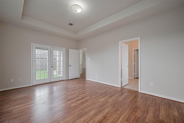 7407 Breda Dr, Baytown, TX 77521 - unfurnished room featuring french doors, light wood finished floors, and baseboards