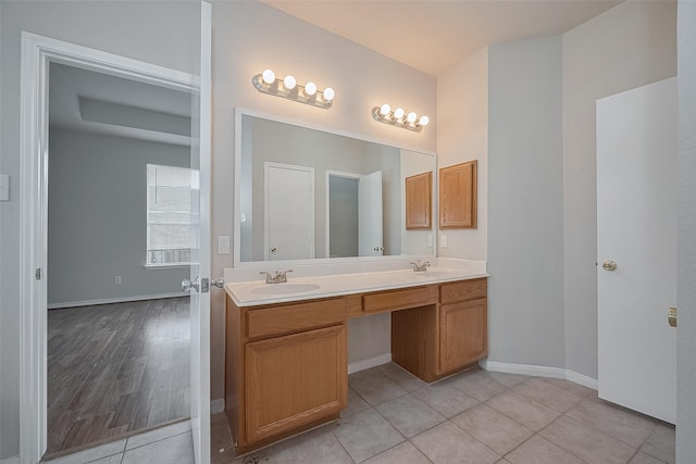 7407 Breda Dr, Baytown, TX 77521 - bathroom with double vanity, tile patterned flooring, and baseboards