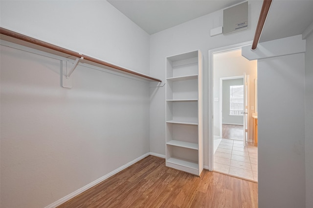 7407 Breda Dr, Baytown, TX 77521 - walk in closet with light wood-type flooring