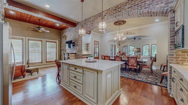 7705 Savannah, Beaumont, TX 77707 - kitchen with a ceiling fan, freestanding refrigerator, dark wood-style flooring, open floor plan, and light countertops