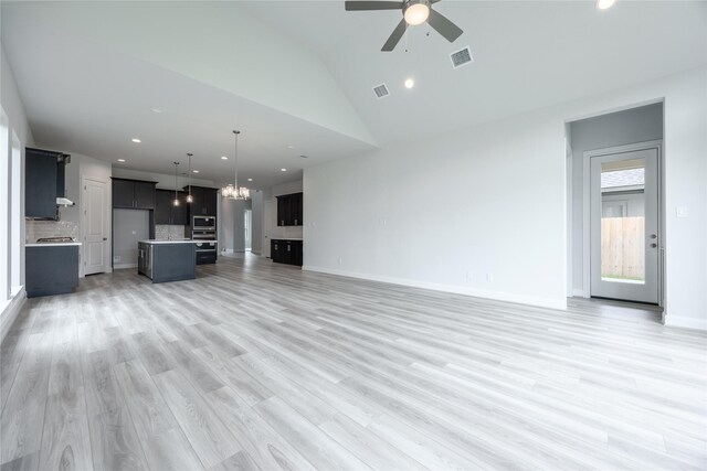 813 Laguna Green Ln, Katy, TX 77493 - unfurnished living room featuring ceiling fan, a chandelier, recessed lighting, vaulted ceiling, and light wood-type flooring