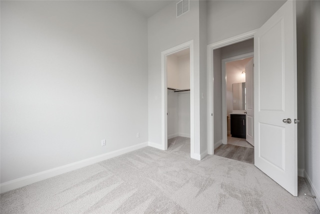813 Laguna Green Ln, Katy, TX 77493 - unfurnished bedroom with light carpet, a spacious closet, and a closet