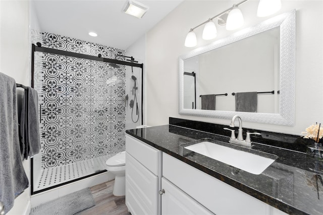 8223 Kingsbrook Rd Unit 212, Houston, TX 77024 - bathroom featuring toilet, vanity, a stall shower, and wood finished floors