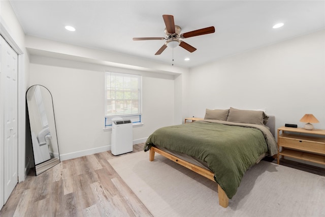 8223 Kingsbrook Rd Unit 212, Houston, TX 77024 - bedroom featuring light wood finished floors, recessed lighting, ceiling fan, and baseboards