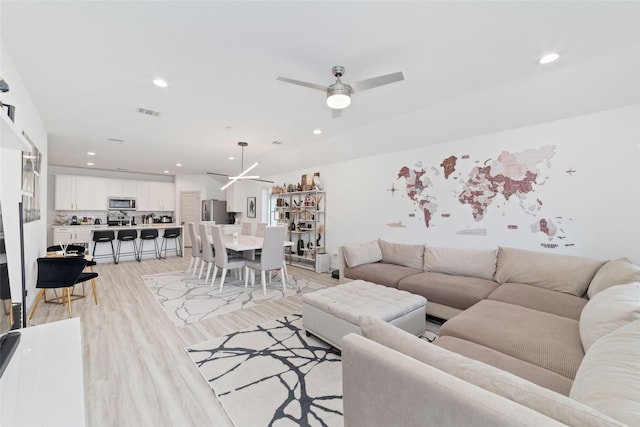 7011 Fleetwood Crescent Way, Richmond, TX 77407 - living area featuring ceiling fan, light wood-style floors, and recessed lighting