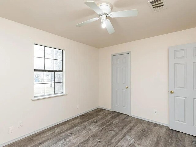 408 S Live Oak St, Mathis, TX 78368 - unfurnished bedroom featuring wood finished floors, baseboards, and a ceiling fan