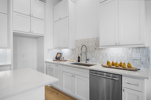 1705 Bologna Ln, Houston, TX 77055 - kitchen with dishwasher, a sink, light countertops, and white cabinetry