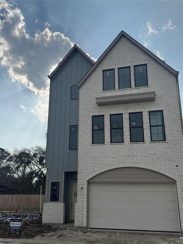 1705 Bologna Ln, Houston, TX 77055 - view of front of property featuring board and batten siding, brick siding, and a garage