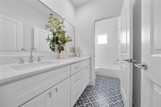 1705 Bologna Ln, Houston, TX 77055 - full bathroom with double vanity, toilet, shower / washtub combination, and tile patterned flooring